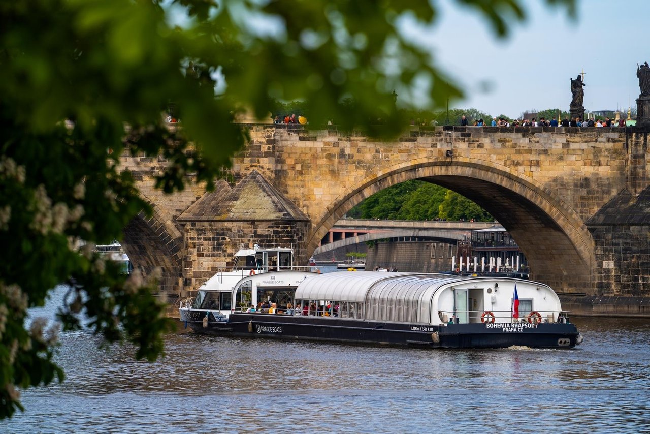Bateau de visite qui va passer sous un pont, le bateau et plein de gens